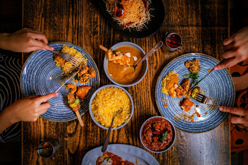 A table with several plates of food at Dhoom in Dunfermline